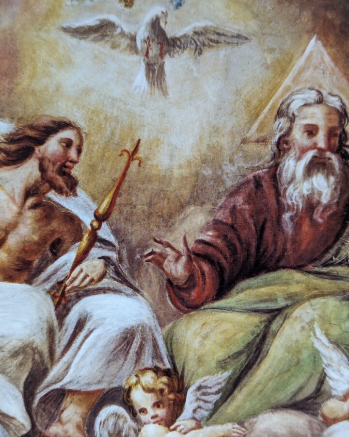 The Most Holy Trinity seated in heaven and surrounded by clouds and angels